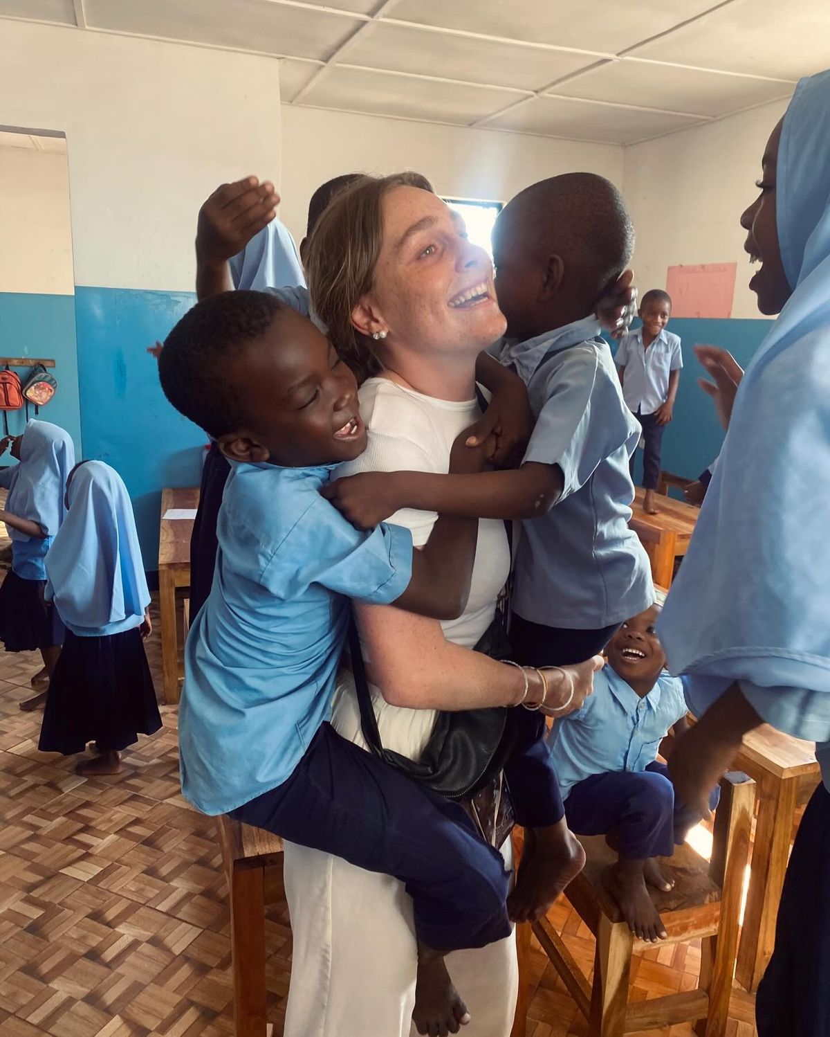 Students learning English with volunteer in Tanzania